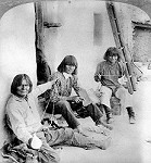 Hopi men processing wool